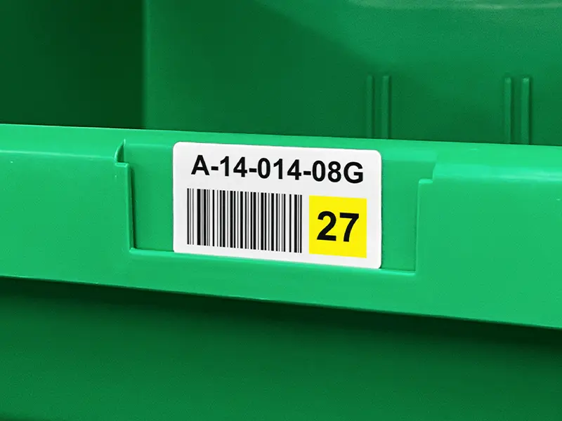 Barcode location label applied to a plastic storage bin