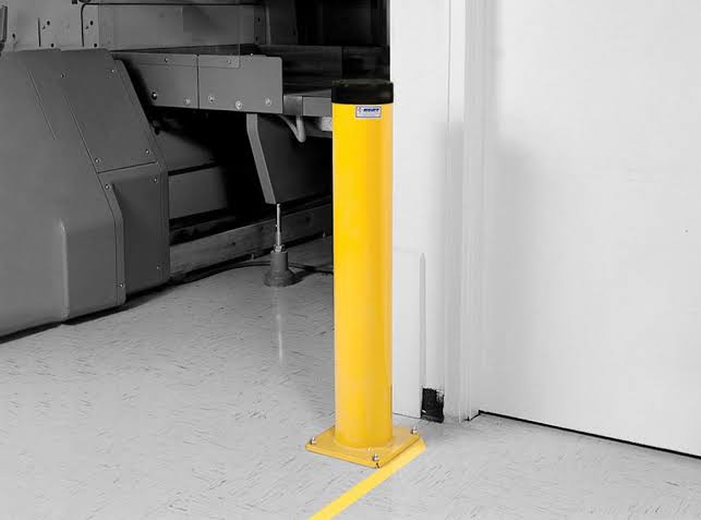 Industrial bollards protecting a warehouse dock door and equipment