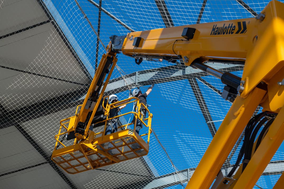 Articulating boom lift active at a commercial construction site