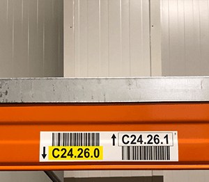 Frost-covered barcode label on a cold-storage warehouse rack