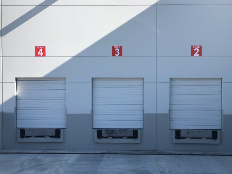 Numbered dock door barcode sign installed at a warehouse loading area
