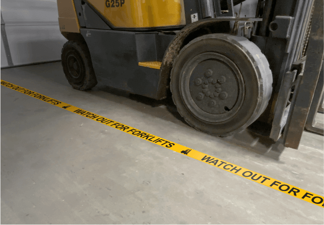 Forklift traffic lane striping with directional arrows on a warehouse floor