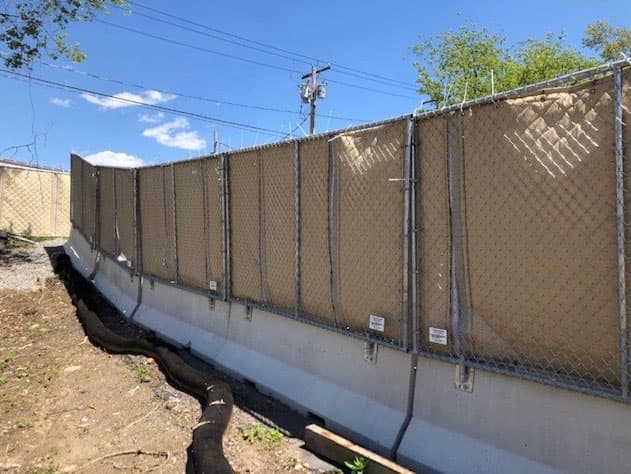 Concrete Jersey barriers with temporary fence panels installed