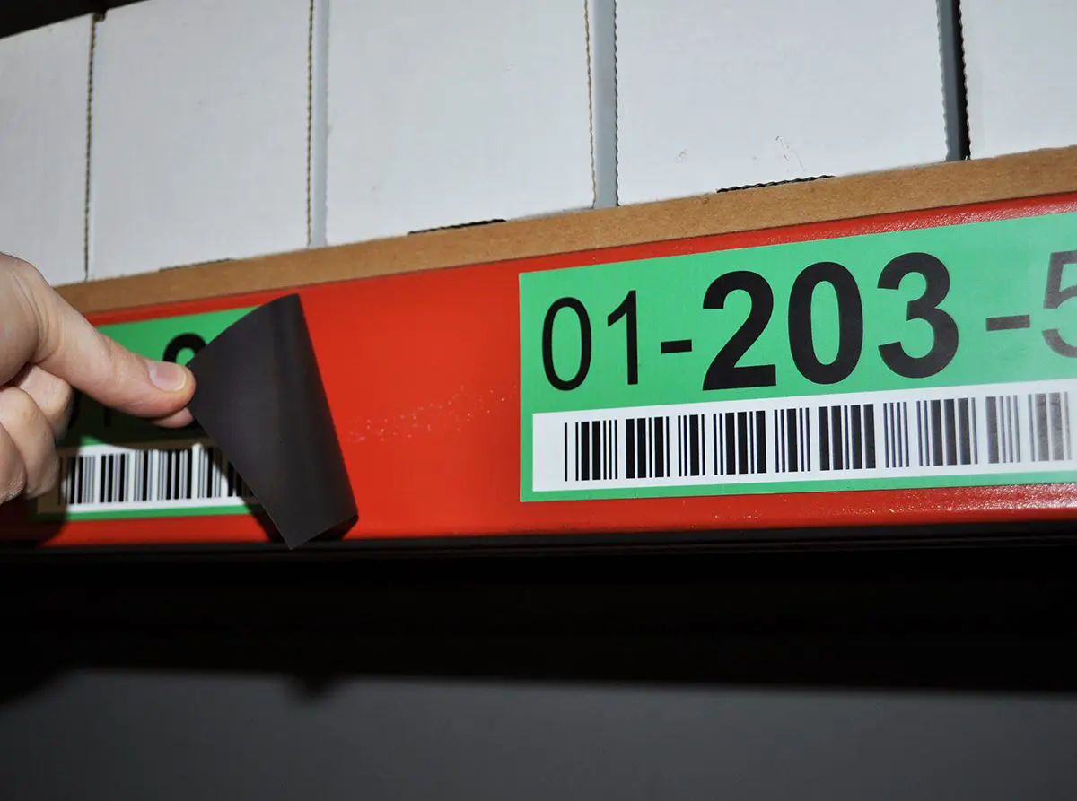 Magnetic barcode label attached to a warehouse rack beam