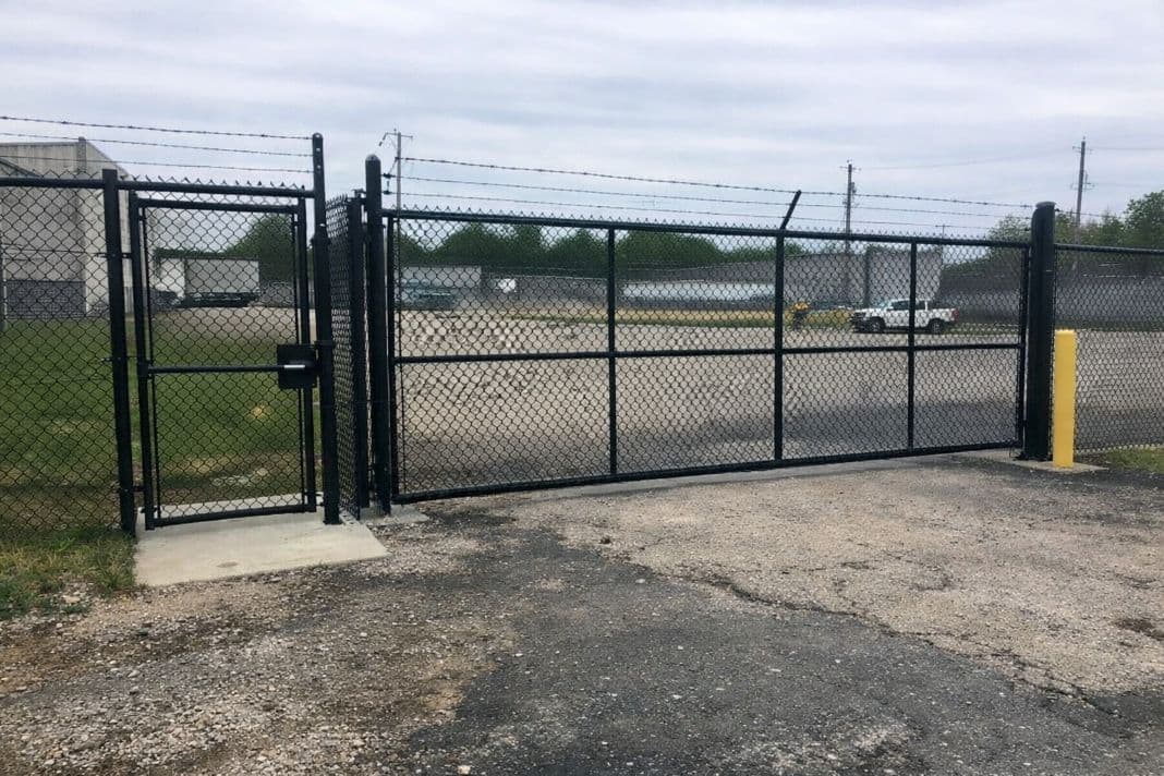 Industrial warehouse perimeter security fence with vehicle gate