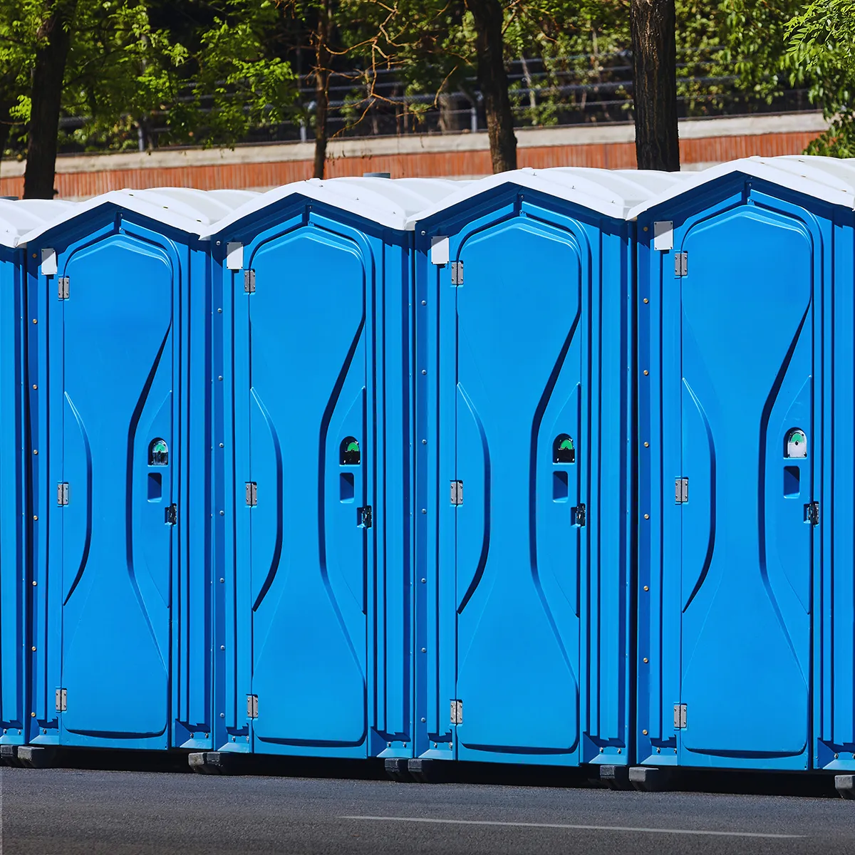 Row of portable restroom units at a commercial construction site