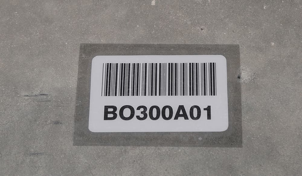 Warehouse floor barcode label installed under a protective cover
