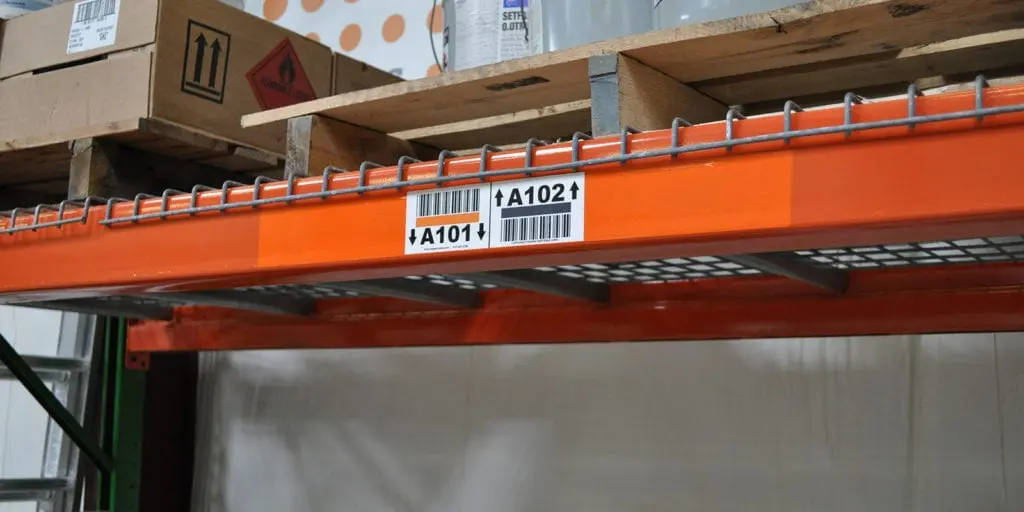 Cover-up relabeling strip applied over an existing warehouse rack barcode label
