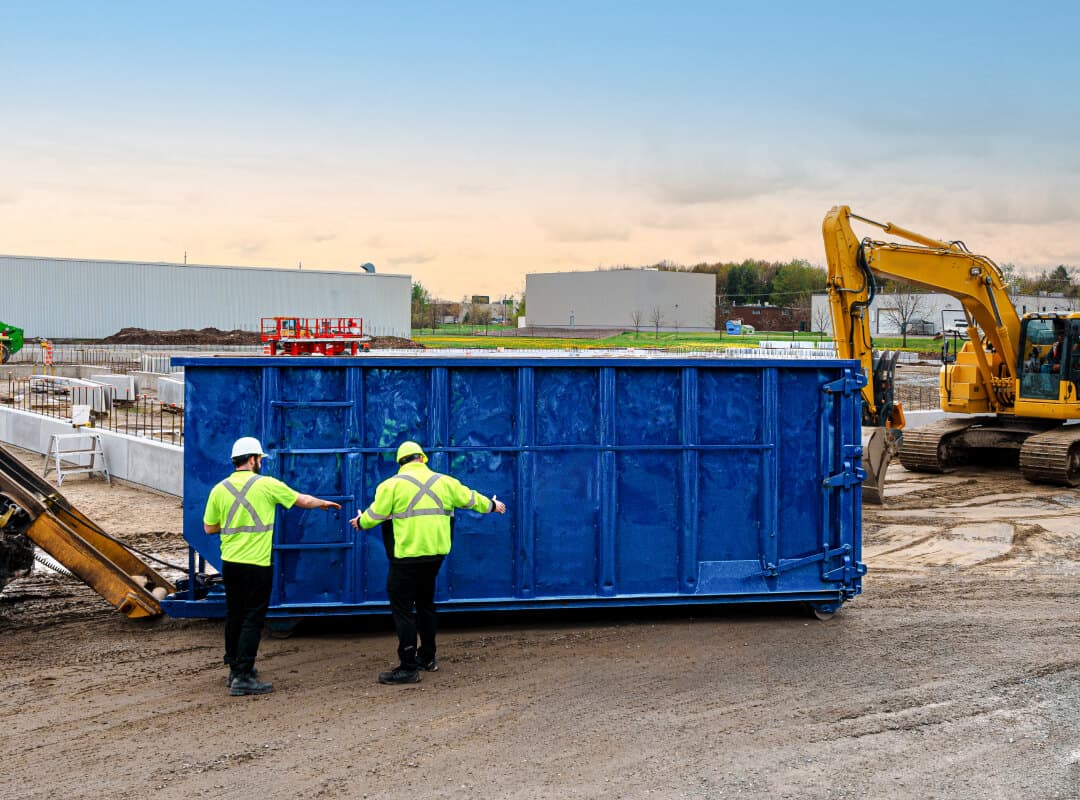 Active roll-off dumpster at a commercial construction site