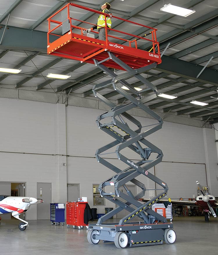 Electric scissor lift inside a warehouse