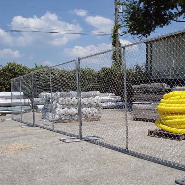 Freestanding temporary chain-link fence panels at a commercial construction site