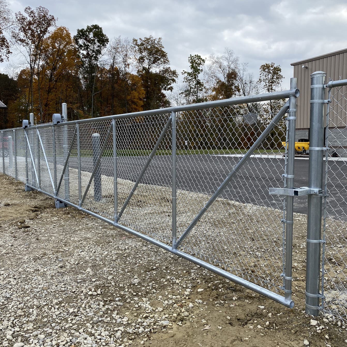 Temporary chain-link vehicle gate at a commercial construction site
