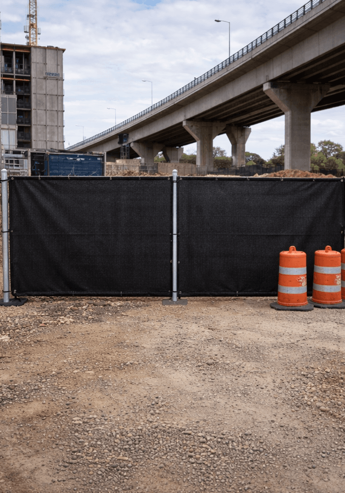 Temporary construction fence with windscreen installed at a commercial site
