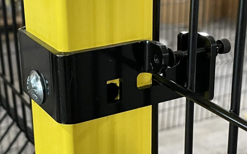 Bolted bracket connecting a wire partition to a yellow post