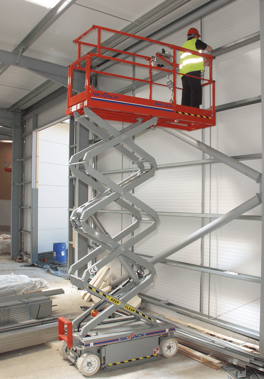 Electric scissor lift inside a warehouse