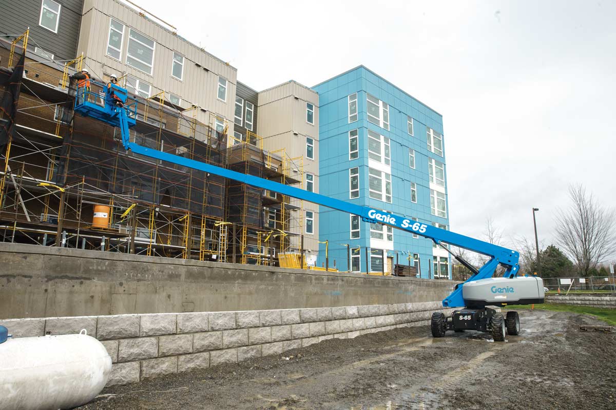 Telescopic boom lift with the complete boom, platform, and base visible