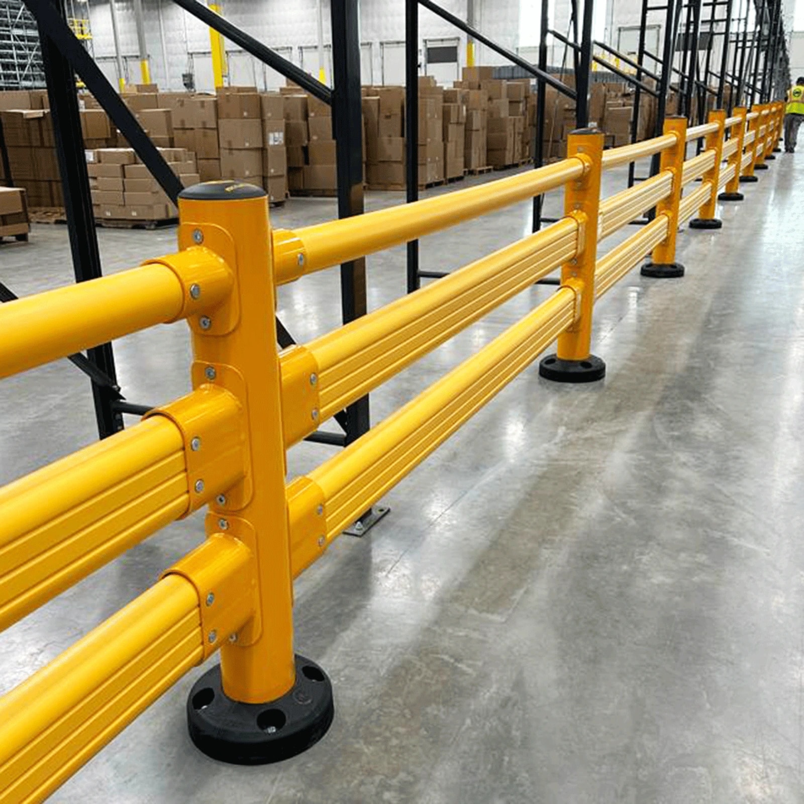 Multi-rail pedestrian barrier beside warehouse racking