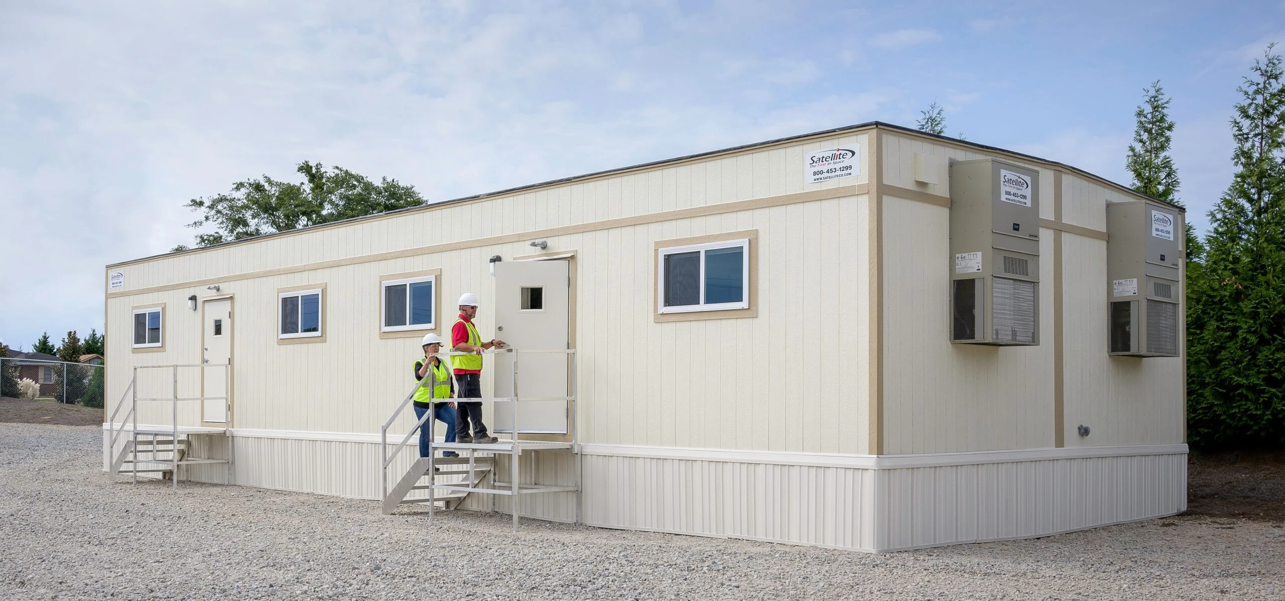 Installed mobile office building with entrance stairs, windows and site personnel