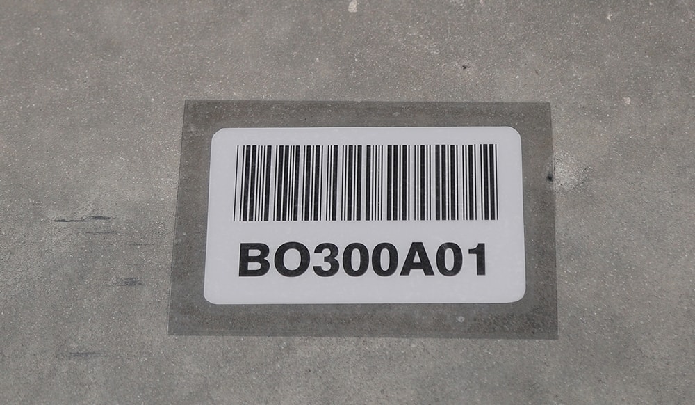 Warehouse floor barcode label installed under a protective cover