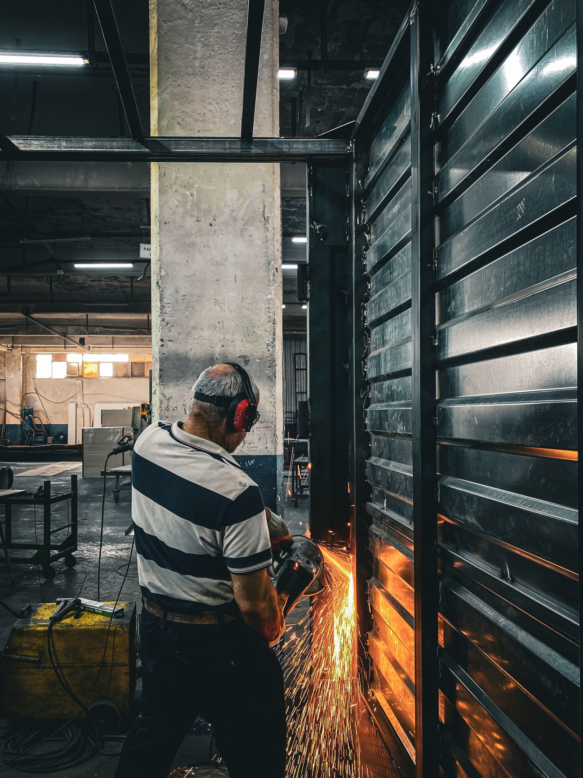 Steel component being worked on with a grinder