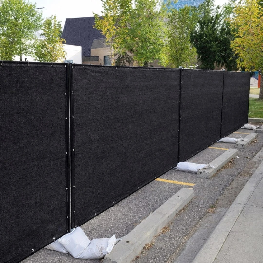 Temporary construction fence with windscreen installed at a commercial site