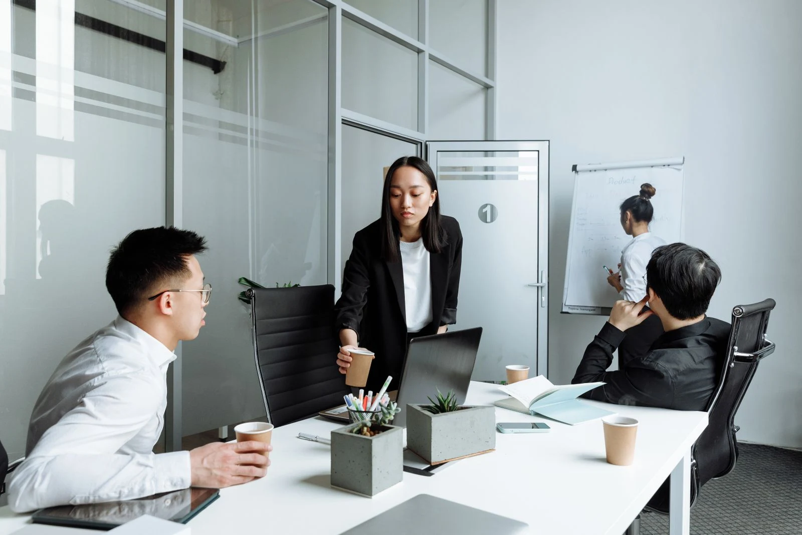 Colleagues collaborating around a table in a bright office