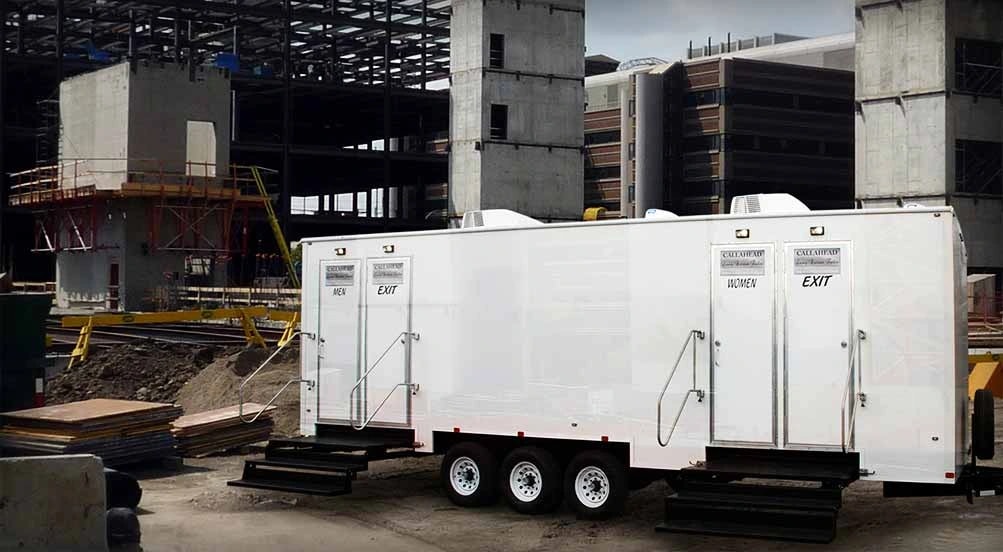 Commercial restroom trailer with steps at a construction site