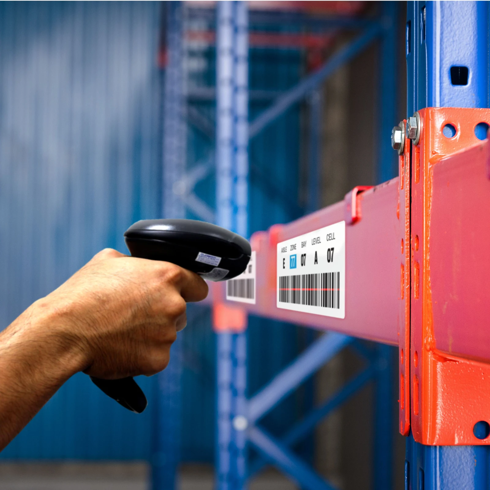 A handheld scanner checking identification in a warehouse