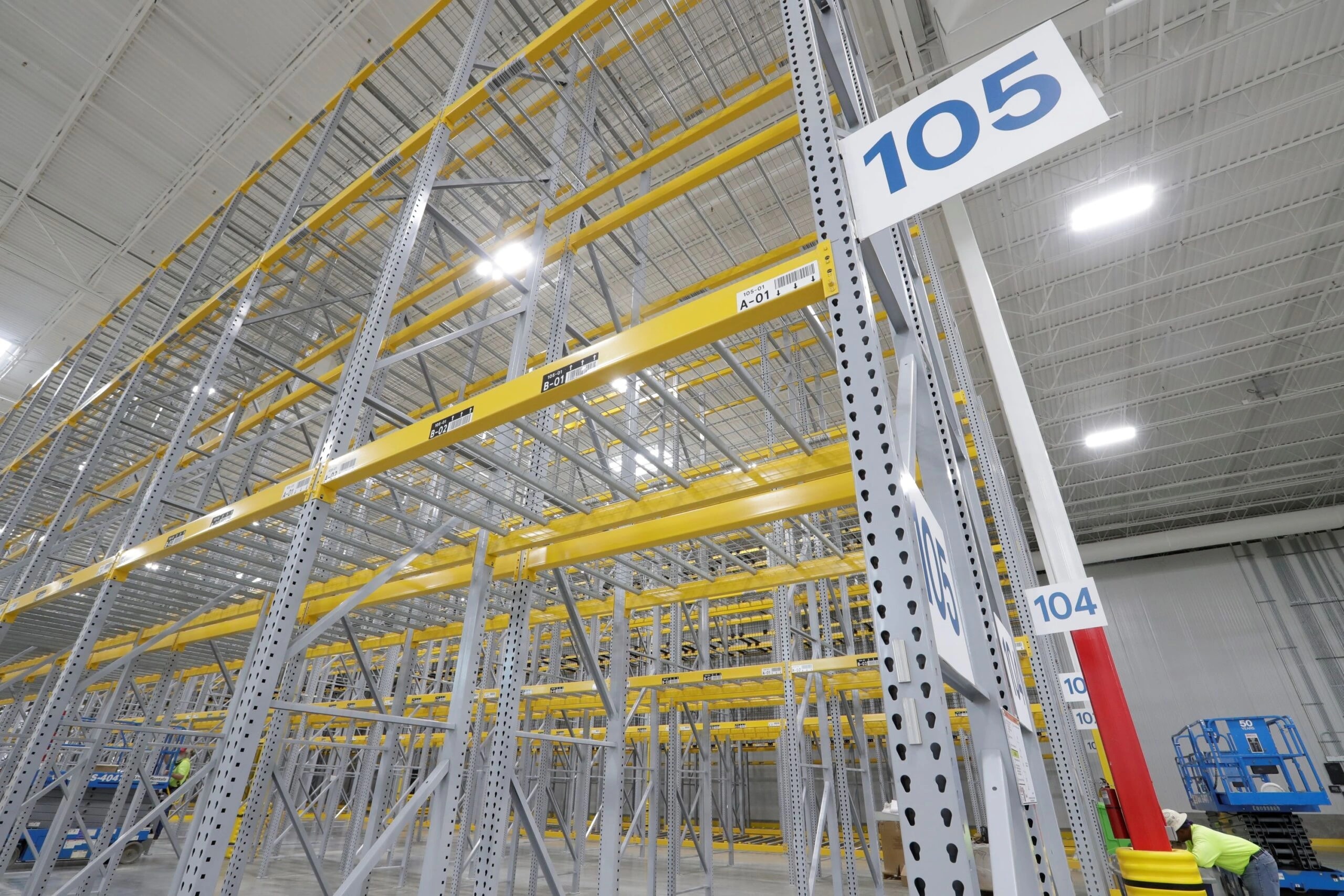 Rack location labels and large aisle markers on warehouse shelving